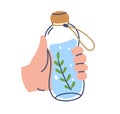 Recycled water bottle in hand. Holding detox aqua drink with rosemary. Healthy summer lemonade, infused beverage with