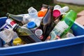 recycling bin filled with bottles, cans, and other recyclables