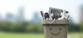 Smiling waste bin full of e-waste Royalty Free Stock Photo