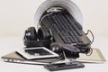 Recycling bin and old digital tablet, cell phone, headphone, cords and electronic devices. Planned obsolescence, e-waste Royalty Free Stock Photo