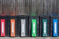 Recycling bins. Common colour coding is blue for paper, grey or black for tins and cans, red for plastics, yellow for textiles, Royalty Free Stock Photo