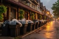 recycling bins and trash bags lined up along the street