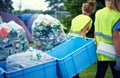 Recycling, community service and volunteer work outdoor with cans and garbage at a park. Cleaning, sustainability and