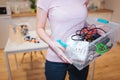 Recycling concept. Mixed electronic waste in recycling contaner close-up. Responsible woman is protecting environment Royalty Free Stock Photo