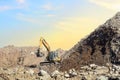 Recycling concrete and construction waste from demolition. Excavator at landfill of the disposa. Reuse of building rubble. Backhoe