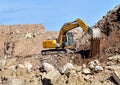 Recycling concrete and construction waste from demolition. Excavator at landfill of the disposa. Reuse of building rubble. Backhoe