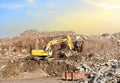 Recycling concrete and construction waste from demolition. Excavator Liebherr at landfill of the disposa. Reuse of building rubble
