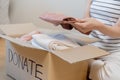 Recycling, Donation for poor, asian young woman, girl sitting pack on floor at home, holding donate box full with second hand Royalty Free Stock Photo