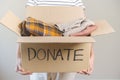 Recycling, Donation for poor, asian young woman pack, hand in holding donate box full with second hand clothes, charity helping