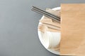 Wooden forks, knives and paper cups on plate Royalty Free Stock Photo