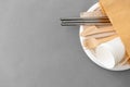 Wooden forks, knives and paper cups on plate Royalty Free Stock Photo