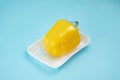 Recycling and environment concept: fresh yellow paprika in plastic package. Royalty Free Stock Photo