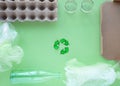 Recycling. Green recycle eco symbol. Recycled arrows sign near materials for recycle and reuse cardboard, glass bottle Royalty Free Stock Photo