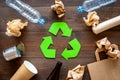 Recycling. Green recycle eco symbol. Recycled arrows sign near matherials for recycle and reuse on dark wooden Royalty Free Stock Photo