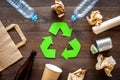 Recycling. Green recycle eco symbol. Recycled arrows sign near matherials for recycle and reuse on dark wooden Royalty Free Stock Photo