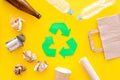 Recycling. Green recycle eco symbol. Recycled arrows sign near matherials for recycle and reuse on yellow background top Royalty Free Stock Photo