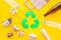 Recycling. Green recycle eco symbol. Recycled arrows sign near matherials for recycle and reuse on yellow background top Royalty Free Stock Photo