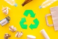 Recycling. Green recycle eco symbol. Recycled arrows sign near matherials for recycle and reuse on yellow background top Royalty Free Stock Photo