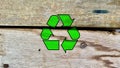 Bright recycling icon isolated on waste wooden board background Royalty Free Stock Photo