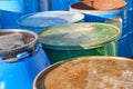 Recycling industry - Rusty metal barrels stacked in rows, toxic waste. Royalty Free Stock Photo