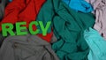 Recycling made of letters on multicolored textile background, overconsumption