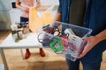 Recycling. Mixed electronic waste in plastic contaner close-up. Responsible man is protecting environment while sorting Royalty Free Stock Photo