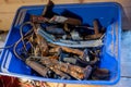 Recycling old rusty scrap metal in blue palstic box