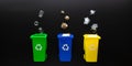 Recycling set bins. Yellow, green, blue dustbin for recycle plastic, paper and glass can trash on black background Royalty Free Stock Photo