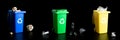 Recycling set bins. Yellow, green, blue dustbin for recycle plastic, paper and glass can trash isolated on black Royalty Free Stock Photo