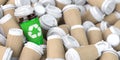 Recycling sign on one of the heap of many empty paper coffee cups