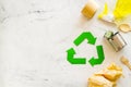 Recycling symbol and different garbage for ecology on marble background top view Royalty Free Stock Photo