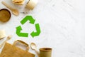 Recycling symbol and different garbage, paper bag, cup, flatware for ecology on marble background top view mock up Royalty Free Stock Photo