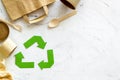 Recycling symbol and different garbage, paper bag, cup, flatware for ecology on marble background top view mock up Royalty Free Stock Photo