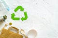 Recycling symbol and different garbage, paper bag, plastic bottle for ecology on white background top view mock up Royalty Free Stock Photo