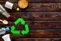 Recycling symbol and different garbage on wooden background top view copyspace Royalty Free Stock Photo