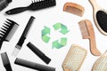 Recycling symbol and different hairbrushes on background, top view Royalty Free Stock Photo