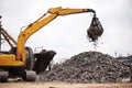 Recycling is tough business. a crane at work in a dumpsite. Royalty Free Stock Photo