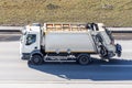 Recycling white truck rides on the road in the city