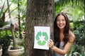 Recycling: woman in forest with recycle sign Royalty Free Stock Photo