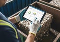 Recycling worker analyzing data on tablet for improved efficiency Royalty Free Stock Photo