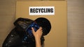 Recycling written on box, female hand putting plastic bottles inside, utilize