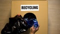 Recycling written on box, female hand putting plastic bottles inside, utilize