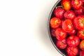 Red acerola cherries fruit in a ceramic bowl isolated on a white background. Royalty Free Stock Photo