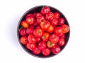 Red acerola cherries fruit in a ceramic bowl isolated on a white background. Royalty Free Stock Photo