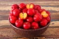 Red acerola - malpighia glabra, tropical fruit in bowl on table Royalty Free Stock Photo