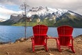 Red Adirondack Chairs at Lake Minnewanka in Banff National Park Royalty Free Stock Photo