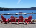 Red Adirondack Chairs- Four by the Lake Royalty Free Stock Photo