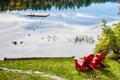 Red Adirondack Chairs on the Shore of a Lake Royalty Free Stock Photo