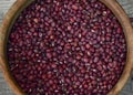 red aduki beans in wooden bowl on wooden floor viewed from above