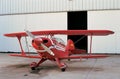 Red aeroplane and hangar in aerodrome Royalty Free Stock Photo